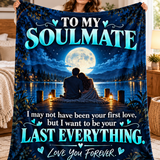 A woman holds up a large fleece blanket featuring a romantic night scene with a couple sitting by a lake under a full moon, with the text 'TO MY SOULMATE' and 'I may not have been your first love, but I want to be your LAST EVERYTHING. Love You FOREVER.
