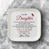 A square white ceramic plate with rounded corners, featuring black printed text and a heart graphic that reads 'difference maker' on a gray and white marble background.